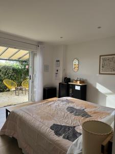 a bedroom with a large bed in a room with a patio at Patios di pruno Suite MELO in Figari
