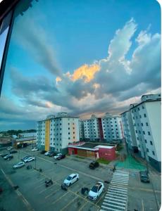 a parking lot with parked cars in a parking lot at Apartamento Com Piscina prox a BR in Ananindeua