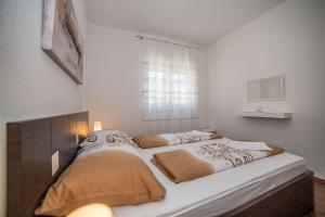 Posteľ alebo postele v izbe v ubytovaní Apartments Kati