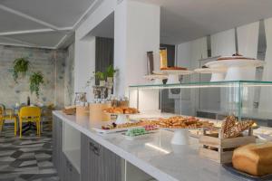 a kitchen with a buffet of food on a counter at Miramare Resort in Rimini