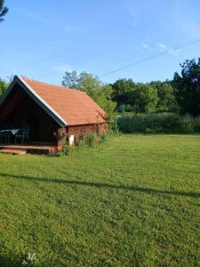 a house with a red roof in a field at Hidden Nest For Two in Herceg-Novi