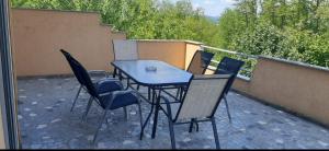 a table and chairs sitting on a patio at Vikendica Sana in Sanski most +12 photos