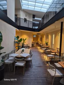 a restaurant with tables and chairs in a room at Stari Grad in Kragujevac