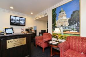 a waiting room at a capital city inn with two chairs and a table at Capital City Inn Sacramento Convention Center CA in Sacramento