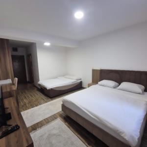 a bedroom with two beds in a room at Apartmani Han in Bijelo Polje +3 photos