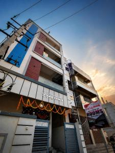 a building with a sign on the side of it at Sai krishna residency in Pithāpuram