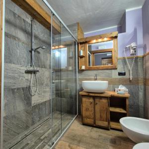 a bathroom with a glass shower and a sink at M4478 Mollino Rooms in Breuil-Cervinia +115 photos