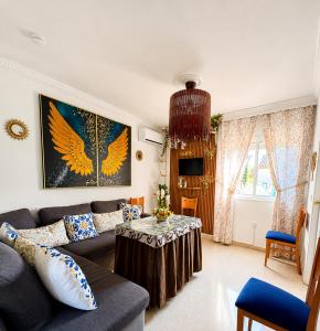 a living room with a couch and a table at Cool Garden Sevilla Aljarafe in Mairena del Aljarafe