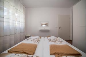 Posteľ alebo postele v izbe v ubytovaní Apartments Kati