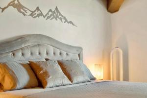 a bedroom with a bed with mountains on the wall at Mansarda Spadone in Musso