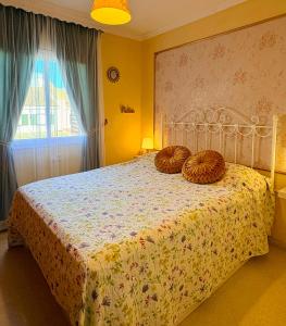 a bedroom with a bed with two pillows on it at Cool Garden Sevilla Aljarafe in Mairena del Aljarafe