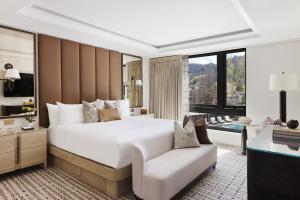 a bedroom with a large white bed and a chair at White Elephant Aspen in Aspen +59 photos
