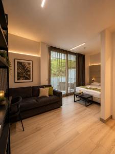 a living room with a couch and a bed at HOTEL VENICE BEACH HVB 34 Lifestyle 4 Superior in Bibione +170 photos