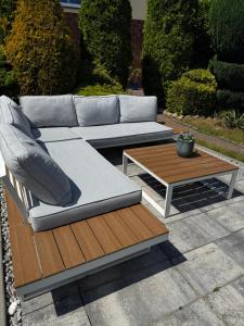 a couch and a coffee table on a patio at Pensjonat Krystyna in Rewa
