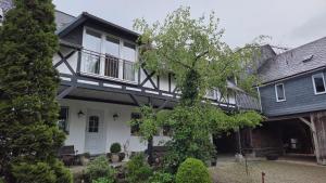 a white house with a black roof at Pferdeglück in Remptendorf
