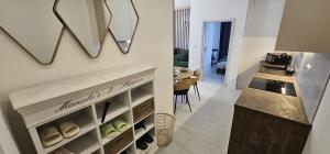 two pictures of a kitchen with a counter and a room at Apartmán na Rohu I in Malacky +1 photo