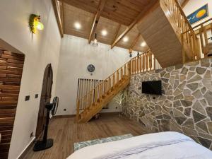 a bedroom with a staircase and a bed in a room at Swiss Chalet Near Murree in Bhāngal