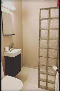 a bathroom with a white toilet and a sink at Otta Studio apartment in Sel +15 photos