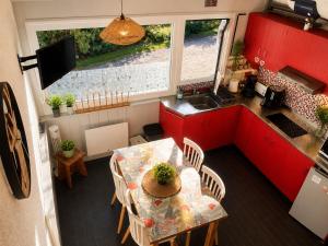 an aerial view of a kitchen with a table and chairs at Cocooning Auvergnat in La Bourboule +9 photos