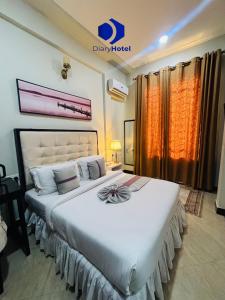 a bedroom with a large white bed in a room at Diary Hotel in Dar es Salaam