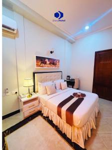 a bedroom with a large bed with a nightstand and a bed sidx sidx sidx at Diary Hotel in Dar es Salaam