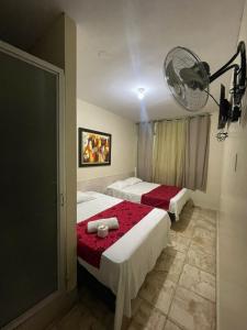 a hotel room with two beds and a fan at Hotel Inca Perú in Piura