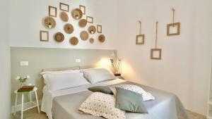 a bedroom with a white bed with pillows on it at Nel Borgo di San Francesco - Ospitalità Diffusa - Relax tra Roccaraso e Costa dei Trabocchi in Villa Santa Maria