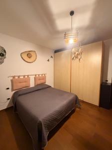 a bedroom with a large bed and a cabinet at villa Cycas in Maratea