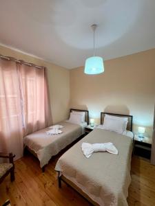 a room with two beds with towels on them at Salve Suite in Lefkada +9 photos