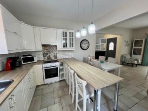 a kitchen with white cabinets and a wooden counter top at Salve Suite in Lefkada