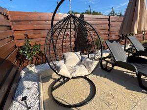 a swinging chair with pillows on a patio at Vila Jovanovic in Bajina Bašta