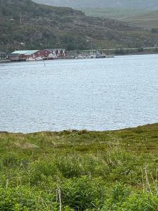 a large body of water with a boat in it at Glassiglo for 2 in Russenes