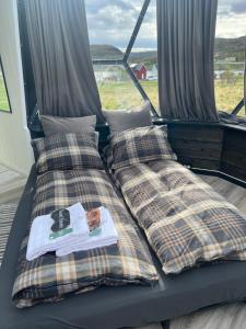 a pair of beds sitting on top of a boat at Glassiglo for 2 in Russenes