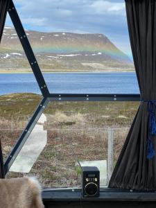 a view of a lake from a window at Glassiglo for 2 in Russenes