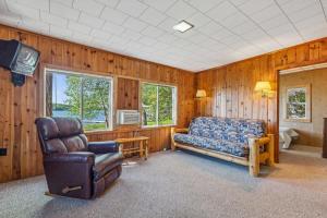 a living room with a couch and a chair at Cabin #9 2BR 1BA Timberlane Resort in Park Rapids