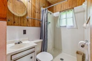 a bathroom with a sink and a toilet and a shower at Cabin #10 2BR 1BA Timberlane Resort in Park Rapids