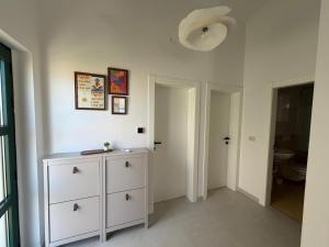 a room with a white dresser and a bathroom at Apartments Salona in Trogir +62 photos