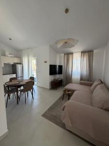a living room with a couch and a dining room at Apartments Salona in Trogir