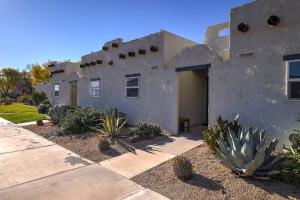 a building with a bunch of cacti in front of it at Relaxing Quiet Resort - Dog Friendly in St. George