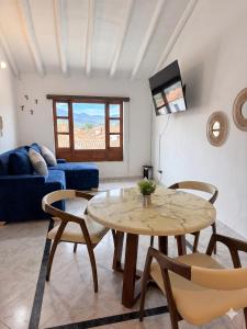 a living room with a table and chairs and a couch at Casa Hotel Cenit in Villa de Leyva