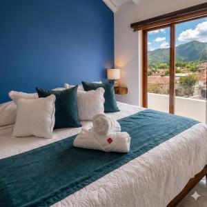 a bedroom with a bed with a towel on it at Casa Hotel Cenit in Villa de Leyva