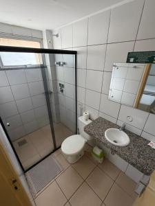 a bathroom with a shower and a toilet and a sink at Hotel Itapoã in Teresina +32 photos