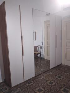 a room with white cabinets and a mirror at Casa Carolina in Surano