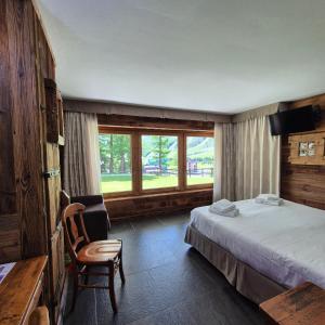 a hotel room with a bed and a window at M4478 Mollino Rooms in Breuil-Cervinia