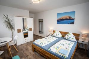 a bedroom with a bed and a table and a mirror at Haus Weisl in Erlsberg
