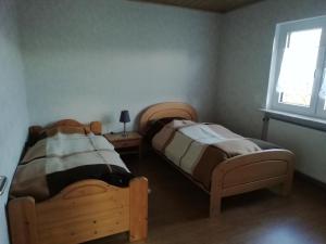 ein Schlafzimmer mit zwei Betten und einem Fenster in der Unterkunft Kleegarten in Eppelborn