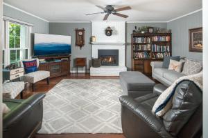 a living room with a couch and a tv and a fireplace at Bella Di Lago in Wilkesboro +44 photos