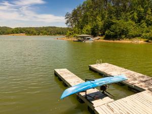 a boat is sitting at a dock on a lake at Bella Di Lago in Wilkesboro