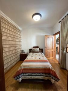 a bedroom with a large bed in a room at Riberas del Valle in Cuenca