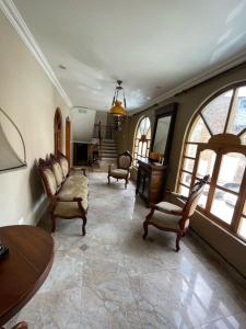a large living room with chairs and a table at Riberas del Valle in Cuenca +9 photos